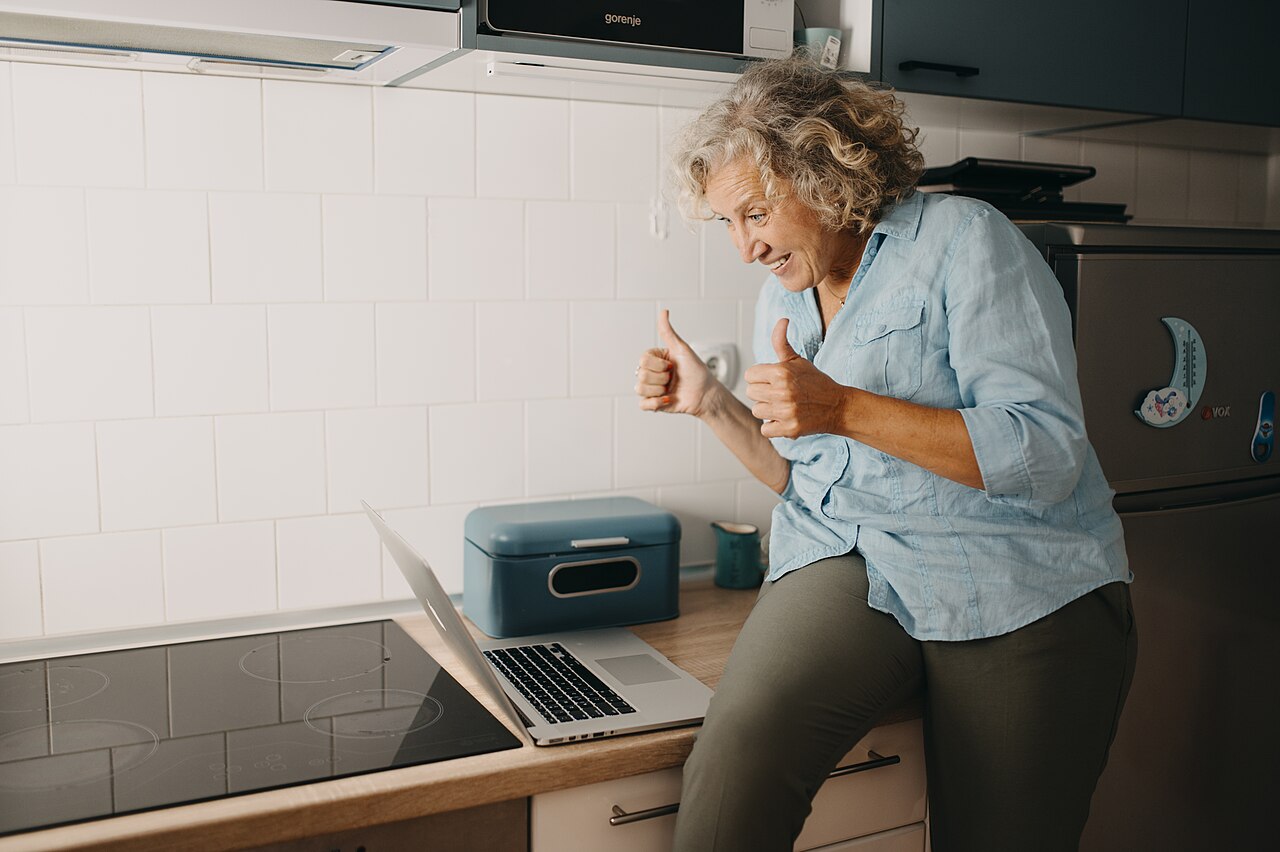 A joyful reaction to good news on a laptop